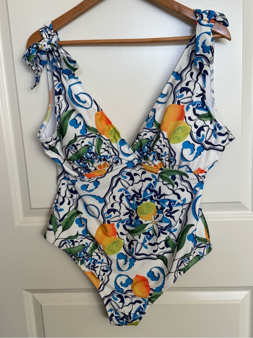 The Chic Hero White Swimsuit with Blue Tile Motifs and Citrus Accents